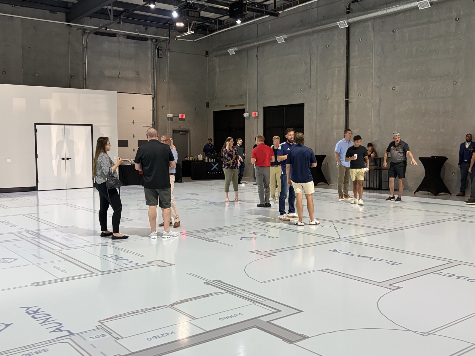 Industry reception with guests mingling on a full-scale projected floor plan