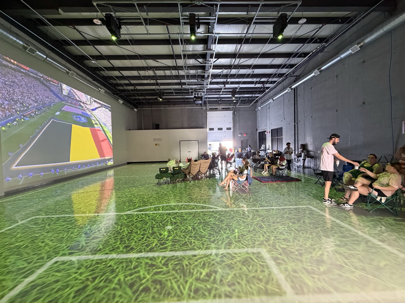 Guests gathered in the studio with the projection wall lit