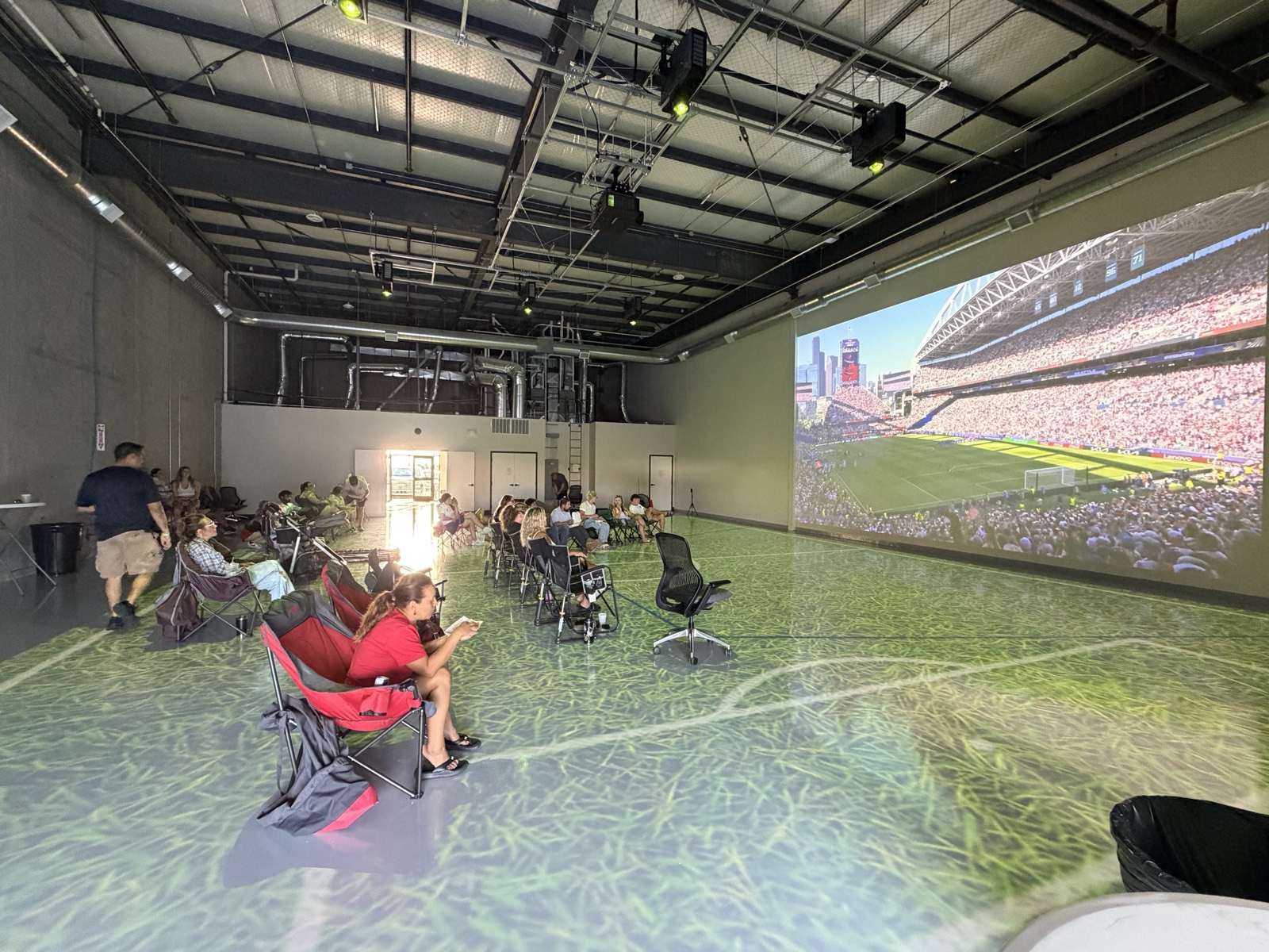 A full crowd in the studio during a projected watch party