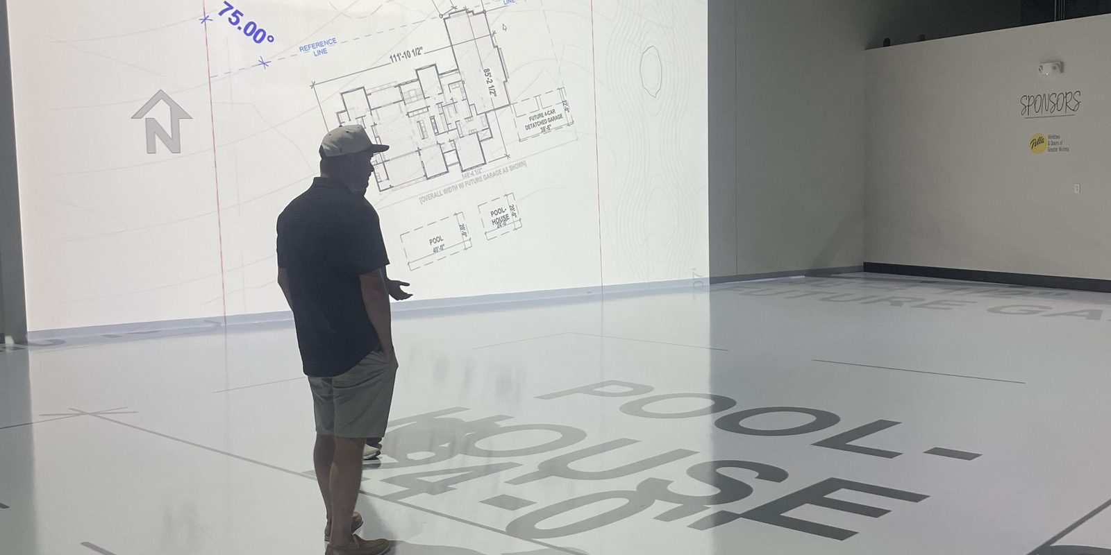 A site plan projected across the studio floor