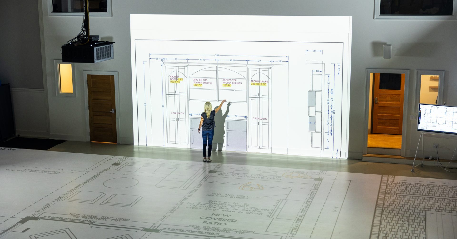 A floor plan projected at full scale across the studio floor