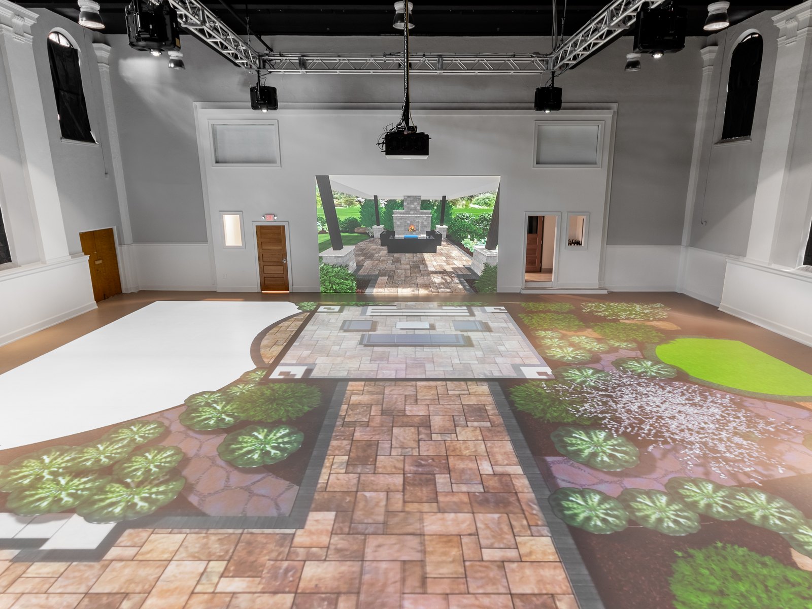 A garden environment projected across the entire floor and walls of the studio